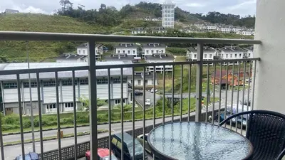 a balcony with a table and a view of a building at GUNONG HOMESTAY at Golden Hills CameronHighlands in Cameron Highlands