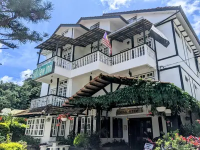 a large white building with an american flag at Hillview Inn Cameron Highlands PROMO in Tanah Rata