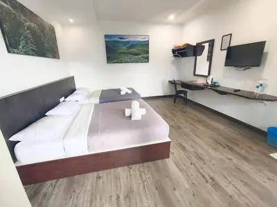 a bedroom with a large bed and a television at Hillview Inn Cameron Highlands PROMO in Tanah Rata