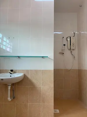 a bathroom with a sink and a shower at \u7231\u6c11\u5bbf Love House in Sitiawan