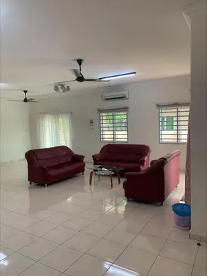 a living room with two couches and a table at \u7231\u6c11\u5bbf Love House in Sitiawan