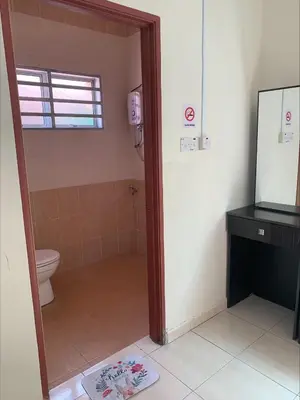 a bathroom with a toilet and a sink and a mirror at \u7231\u6c11\u5bbf Love House in Sitiawan