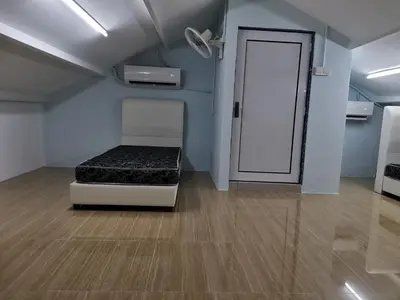 a room with a bed and a door at Color Mixed Home Hostel in George Town