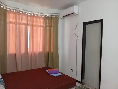a bedroom with a bed and a mirror and a window at Homestay Idaman Penang in Permatang Pauh