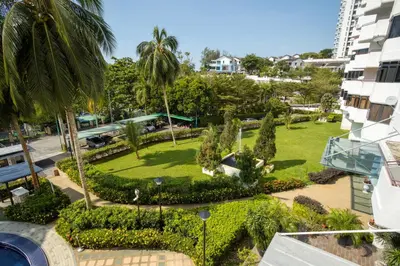 an aerial view of a park with palm trees at Sri Sayang Seaview Holiday Home in Batu Ferringhi