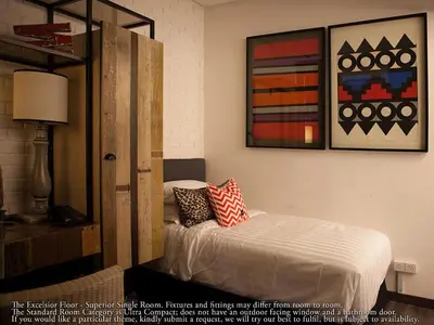 a bedroom with a bed and a painting on the wall at M Boutique Hotel in Ipoh