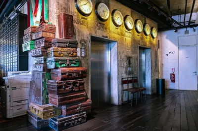 a stack of books on a wall with clocks at M Boutique Hotel in Ipoh