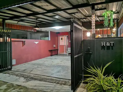an entrance to a building with a red wall at H&T Vintage Decor Homestay in Ipoh