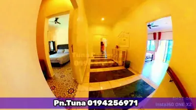 a view of a hallway with a staircase in a house at Tuna Cameron Homstay in Brinchang