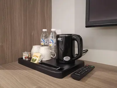 a coffee maker sitting on a table with a remote control at VENO HOTEL in George Town