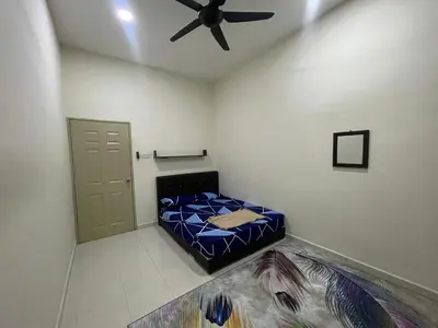a bedroom with a bed and a ceiling fan at No 61 Nazirin Homestay Tmn Indah Raya 2 Manjung Lumut in Lumut