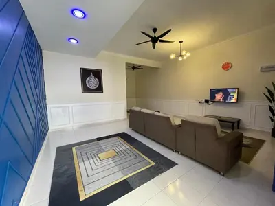 a waiting room with a couch and a ceiling fan at No 61 Nazirin Homestay Tmn Indah Raya 2 Manjung Lumut in Lumut
