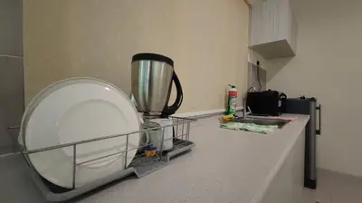 a kitchen counter with a blender and a sink at Marina Island Lumut HomeHotel in Lumut