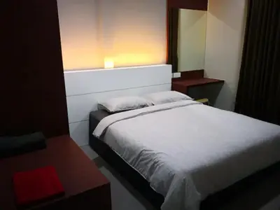 a bedroom with a white bed and a window at CAMERON TROPICA HOMESTAY in Cameron Highlands