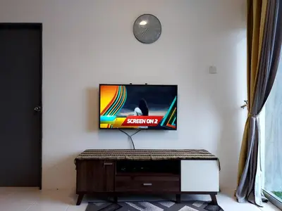 a flat screen tv hanging on a white wall at EMERALD MUSLIM HOMESTAY CAMERON HIGHLANDS in Cameron Highlands