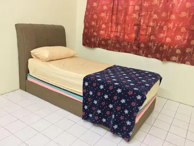 a small bed in a room with a window at Taiping Desa Jana Home Stay in Kamunting