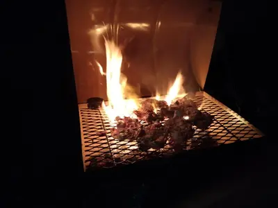 a fire in an oven with some food in it at Casa Villa Homestay Sekinchan in Sekincan