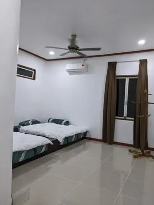 a bedroom with two beds and a ceiling fan at Denai Senja in Kuala Selangor