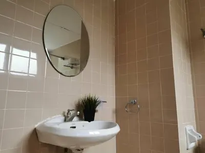 a bathroom with a sink and a mirror at Cozy NEAR-BEACH Apartment - LazyCats' Den in Batu Ferringhi