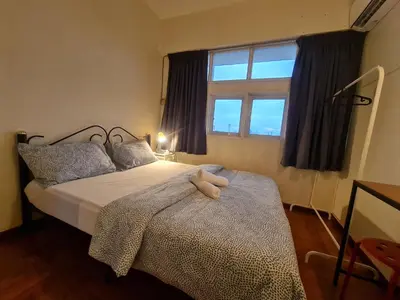 a bedroom with a bed with a stuffed animal on it at JJ Home 2 , Jalan Burmah, Georgetown in George Town