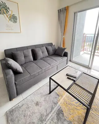 a living room with a couch and a coffee table at Cameron Emerald Avenue Daphne @ Brinchang in Brinchang