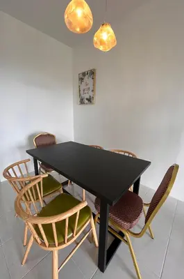 a black table with chairs in a room at Cameron Emerald Avenue Daphne @ Brinchang in Brinchang