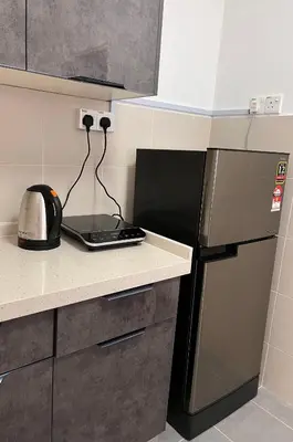 a kitchen with a black refrigerator and a microwave at Cameron Emerald Avenue Daphne @ Brinchang in Brinchang
