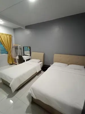 a bedroom with two beds and a desk and a television at Cameron Emerald Avenue Clover @ Brinchang in Brinchang
