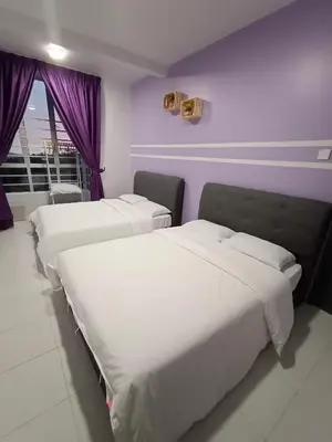 two beds in a room with purple walls at Cameron Emerald Avenue Clover @ Brinchang in Brinchang