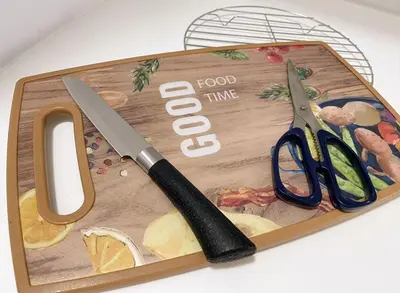 a cutting board with a pair of scissors on it at 2BR Georgetown Luxury Suite #RoofTopPool #Beacon in George Town