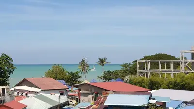a group of houses with the ocean in the background at TESS - By The Sea, Batu Ferringhi Penang in Batu Ferringhi