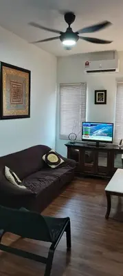 a living room with a couch and a ceiling fan at Citra Cottage Homestay in Sungai Petani