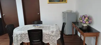 a dining room table with chairs and a table with a bowl on it at Citra Cottage Homestay in Sungai Petani