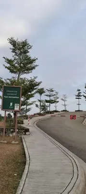 a sidewalk with a sign next to a road at Citra Cottage Homestay in Sungai Petani