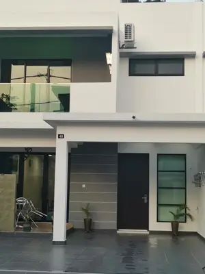 a facade of a building with a black door at 48 \u60a0\u4e4b\u5904NO . 48, PERSIARAN ALAM IMPIAN 3 VILLA RIADAH ALAM IMPIAN PANGKOR, 32300 PANGKOR , PERAK. in Pangkor