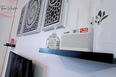 a shelf with a bottle of liquid on a wall at Tiara Homestay 2 with 3 Bedroom, Unlimited Wifi - Brinchang in Brinchang