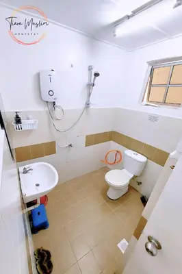 a bathroom with a toilet and a sink at Tiara Homestay 2 with 3 Bedroom, Unlimited Wifi - Brinchang in Brinchang
