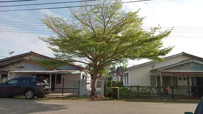 a car parked in front of a house with a tree at Irfans HomestayDouble storey in Seri Manjung