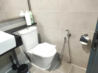 a bathroom with a toilet and a shower at Tropicana 218 Macalister Water Purifier By Blue Sky Holidays in George Town