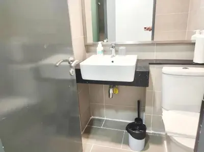 a bathroom with a sink and a toilet at Tropicana 218 Macalister Water Purifier By Blue Sky Holidays in George Town