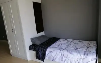 a small bed in a room with a wall at Cozy Studio house /Soho Unit Near Kampar Utar in Kampar