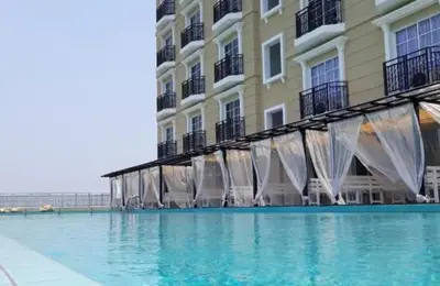 a building with a swimming pool in front of a building at Cozy Studio house /Soho Unit Near Kampar Utar in Kampar
