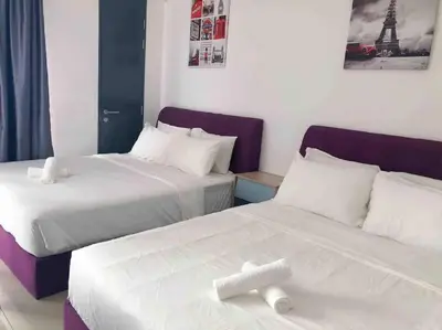 two beds in a hotel room with white sheets at Tropicana 218 Macalister Water Purifier High Floor in George Town