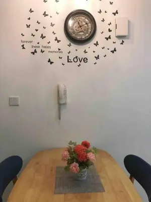 a table with a clock on a wall with black birds at Tropicana 218 Macalister Water Purifier High Floor in George Town