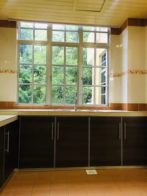 a kitchen with a sink and a large window at BRINCHANG CENTRE 3 ROOMS APARTMENT in Cameron Highlands