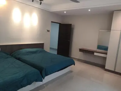 a bedroom with a bed and a mirror on the wall at Orkid Apartment in Cameron Highlands