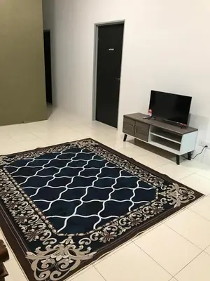 a blue and white rug on the floor in a room at An-Nur Homestay in Sungai Petani