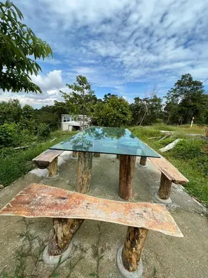 a picnic table with a glass top on top at BUKIT LIMAU REST HOUSE in Taiping