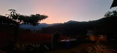 a view of the mountains with a sunset in the background at BUKIT LIMAU REST HOUSE in Taiping