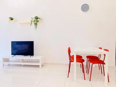 a living room with a white table and red chairs at New Georgetown Modern City View 2BR Homestay for 10pax \u65e0\u654c\u7f8e\u666f\u4e24\u623f\u6c11\u5bbf Beacon Executive Suite in George Town
